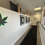 Entry way of a retail store with t-shirt merch inside a hanging frame on the wall