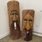 Two faces carved on stones who are smoking